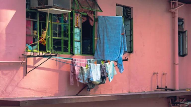 A pink building in Hong Kong with clothes drying on a line