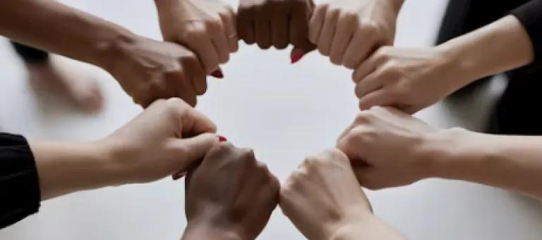 Closed hands making a fist placed in a circle
